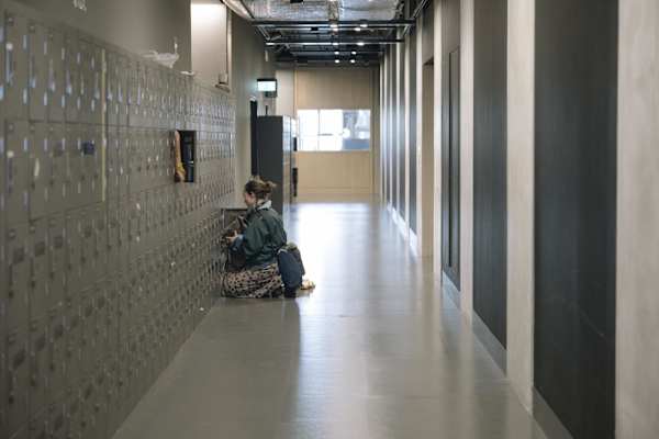 Student in corridor using a locker at East Bank.