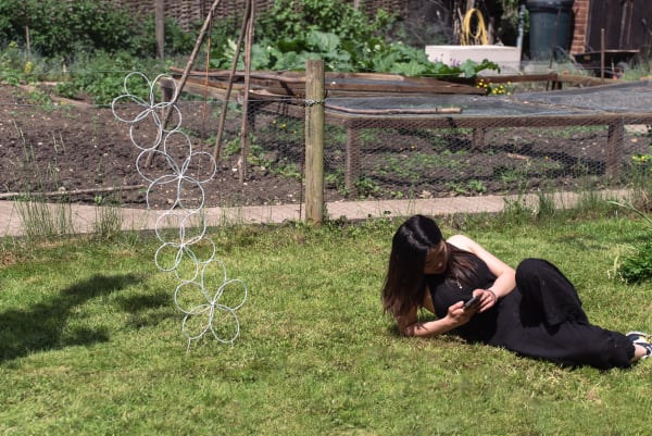 student standing next to their sculpture