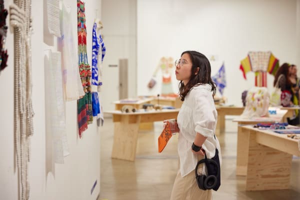 woman looking at wall in gallery