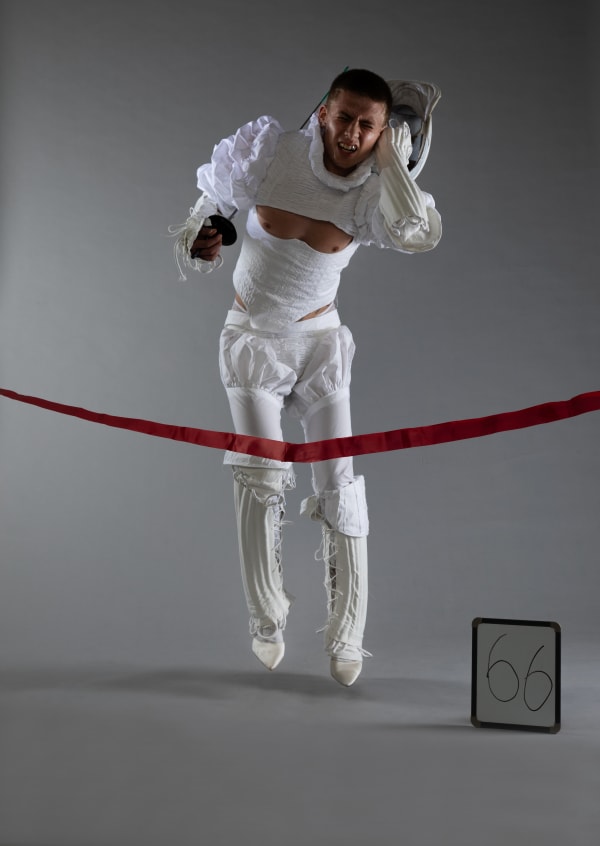 A model in a sculptural head to toe white garment