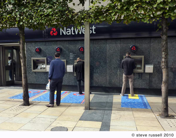 People stood at a Natwest ATM