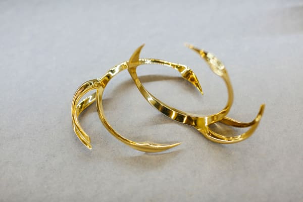 Two interlocked golden bracelets