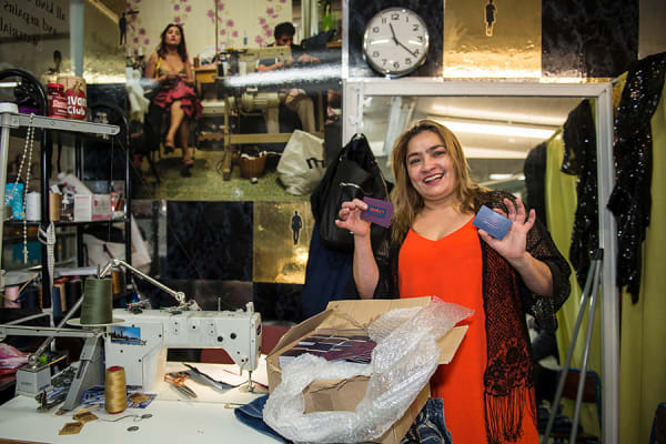 Claudia manages a sewing' business inside the shopping centre. She is receiving her new business cards designed by Lauren Vaughan.