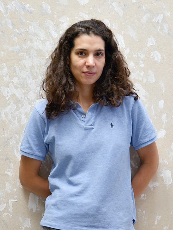 Person standing against a grey background