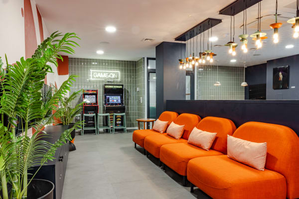 View of the games room featuring the Controller Row and Arcade Zone, showcasing a variety of gaming stations and classic arcade machines.