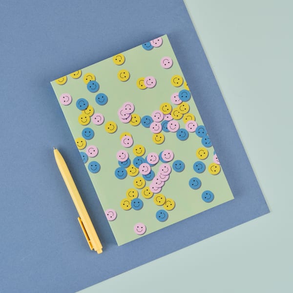 A notebook on a green and blue background