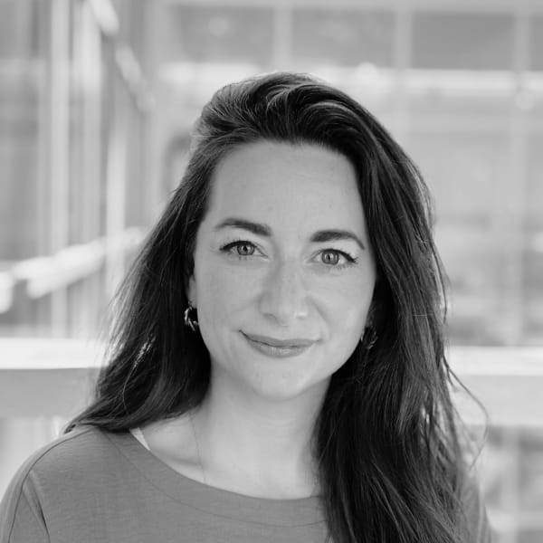 Laura Solomon, R&D Fellow in Textile Science and Technology, with dark brown hair and smiling at the camera