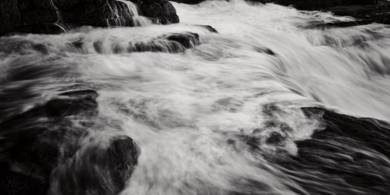 Black and White images of the sea surging towards high tide