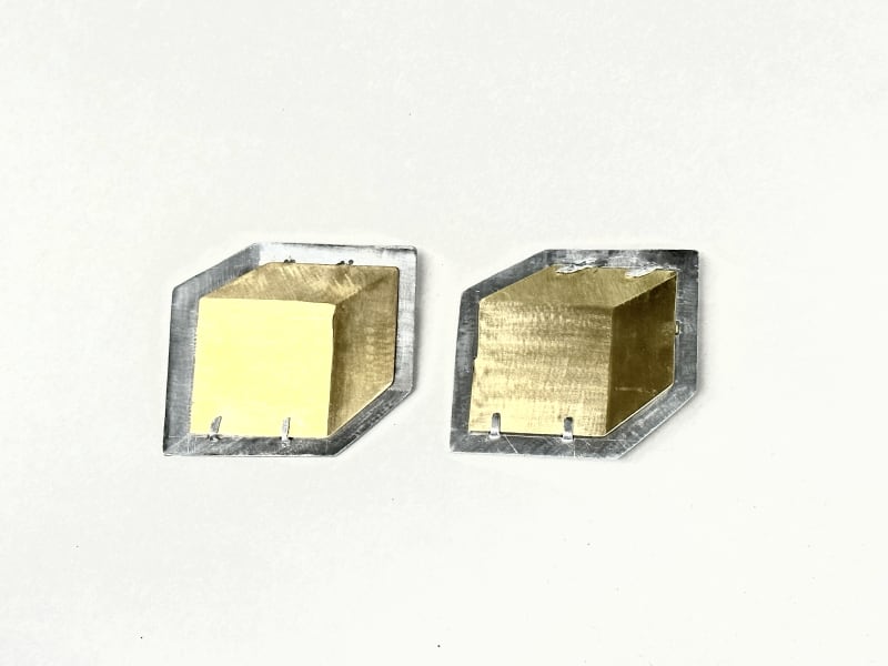 cube in a square space, looks 3d but it's 2d, it was achieved by skillful grinding.