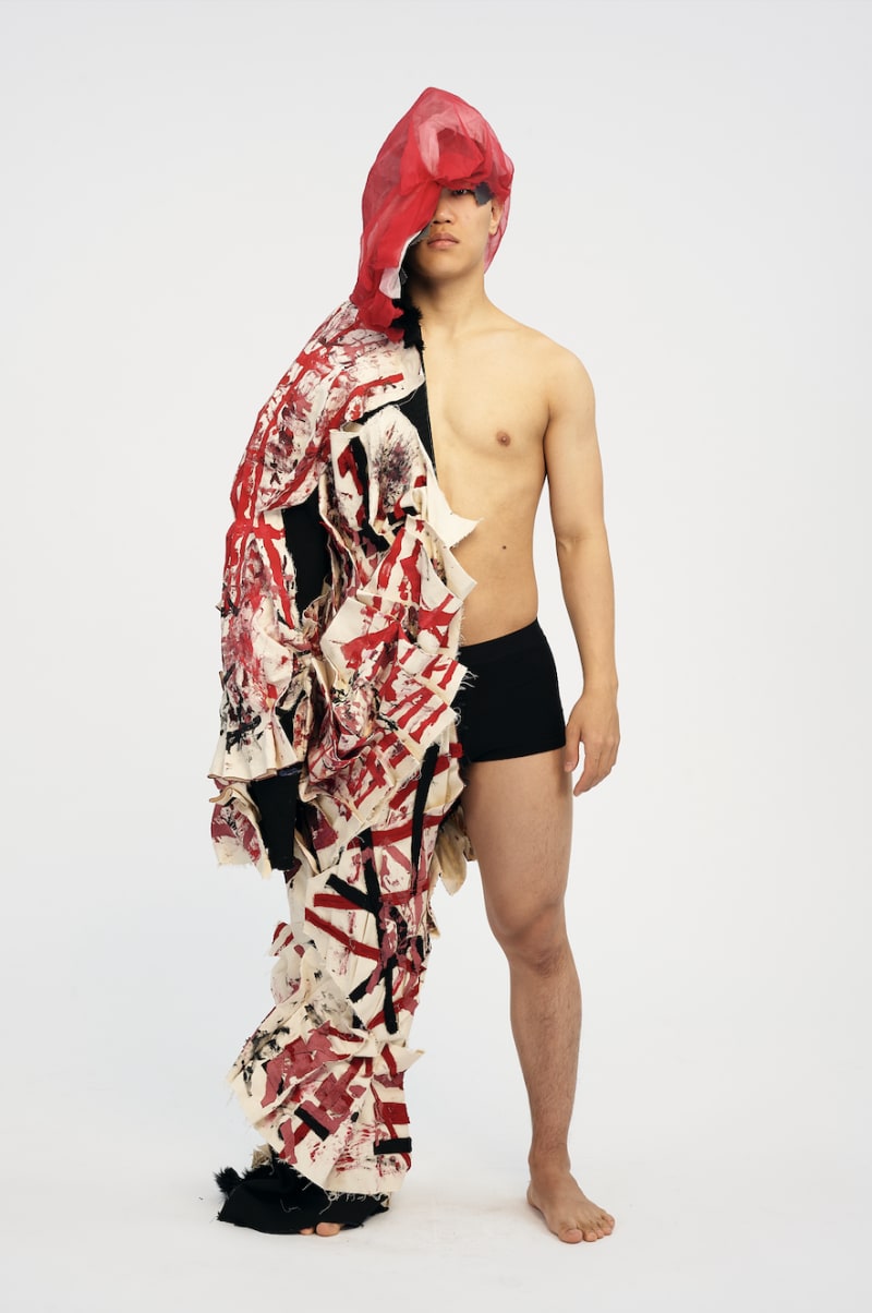 man wearing garment with print and pleating