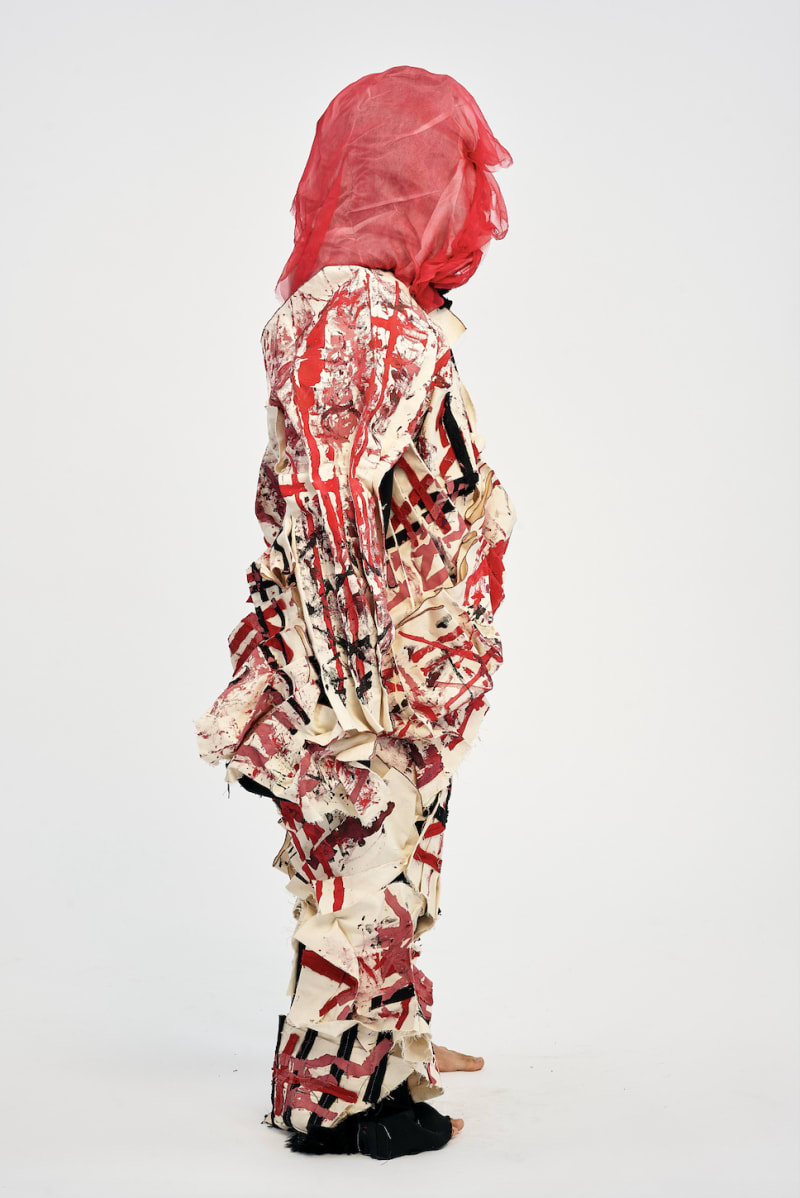 man wearing garment with print and pleating