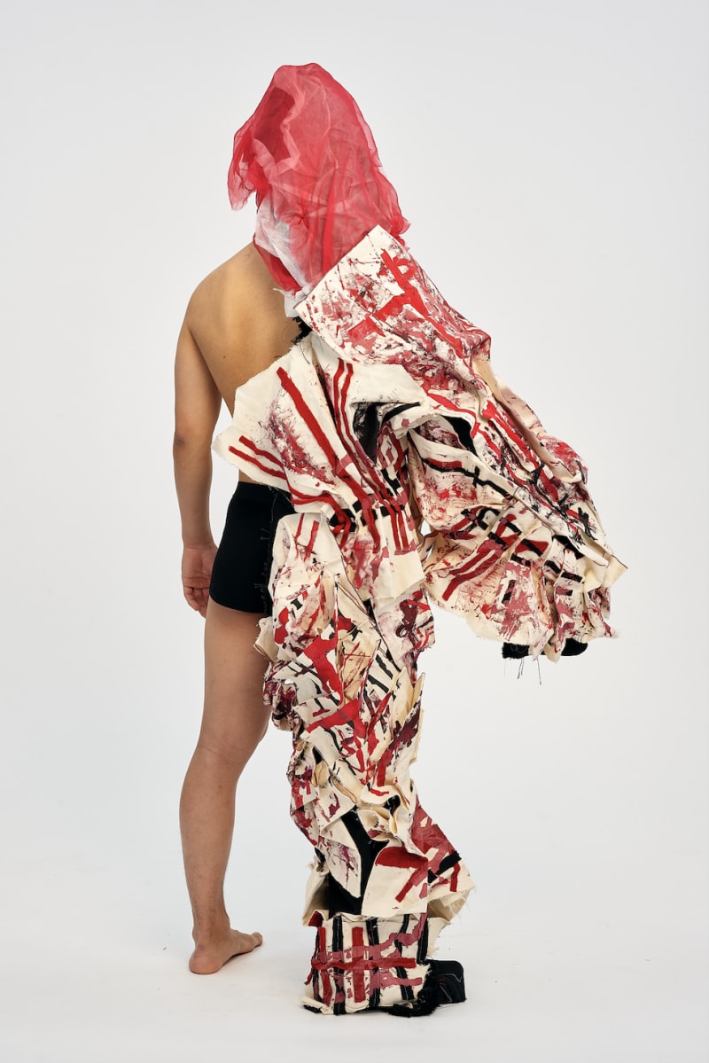 model wearing garment with print and pleating