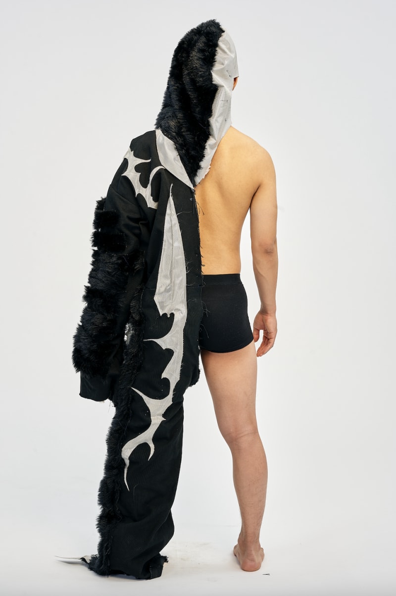 man wearing garment used fur, canvas, metallic reflective fabric