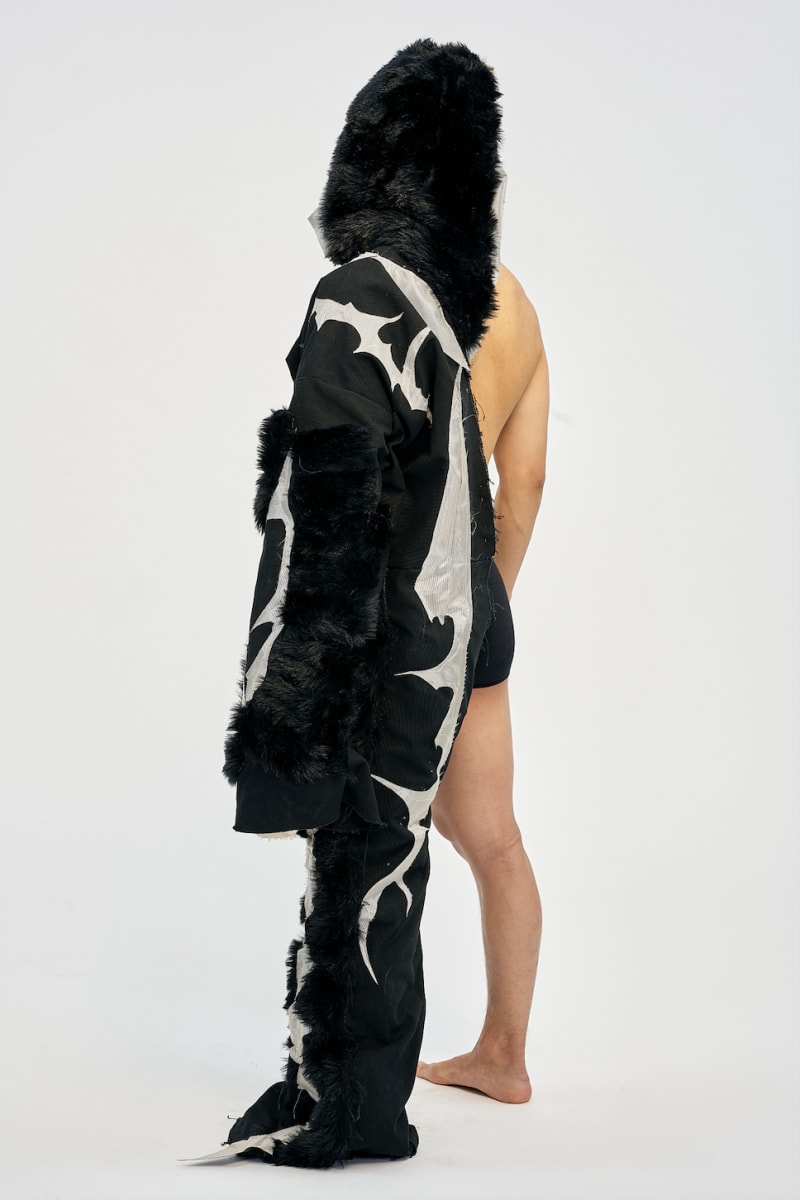 model wearing garment used fur, canvas, metallic reflective fabric.