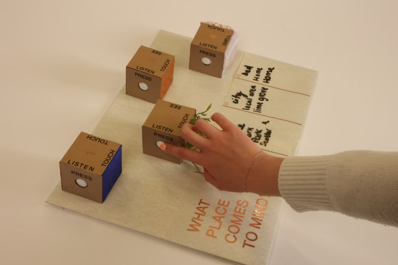 Hand touching the "press" button of one of the cubes.