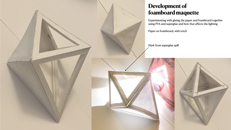 Photos of a maquette of the final piece. The maquette has a foamboard frame and is half covered in a single layer of paper. 