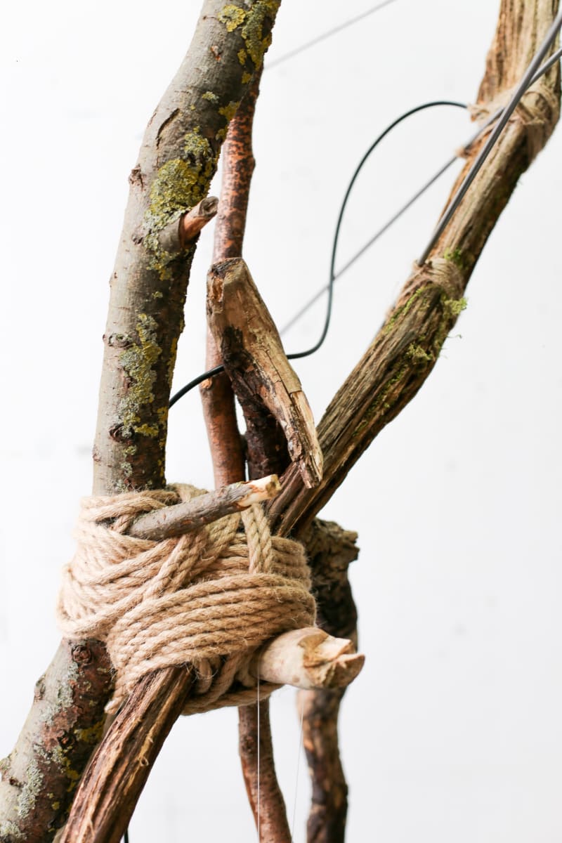 Detail showing material composition: limbs, metal rods, cables, rope