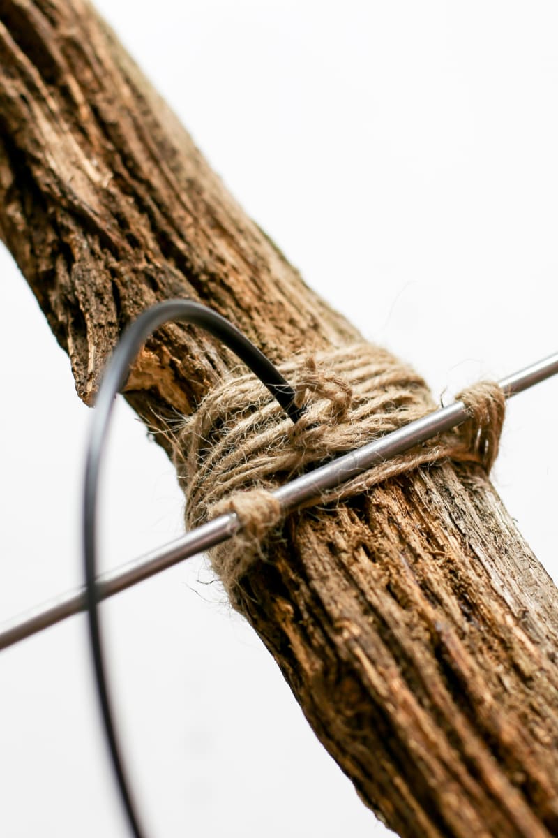 Detail showing material composition: limbs, metal rods, cables, rope
