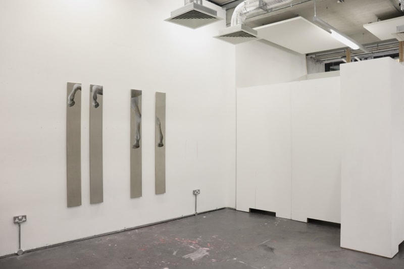Painting of four horse legs on four long slim canvases.