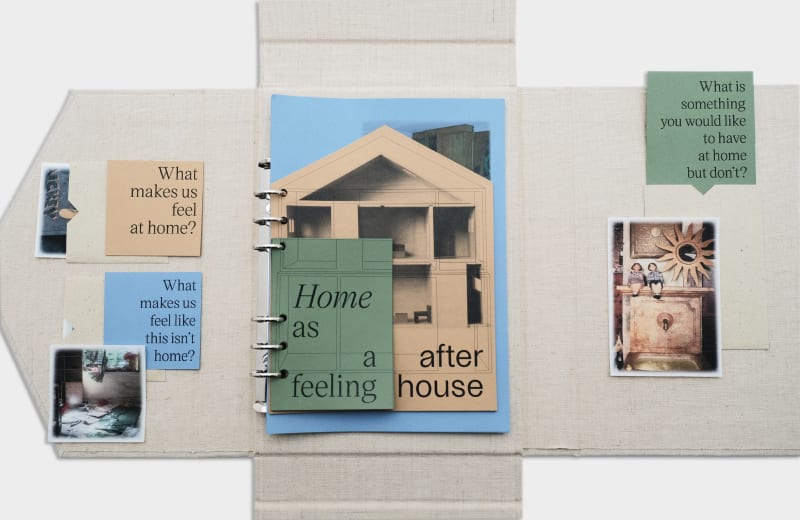 A linen-bound booklet opens to reveal layered pages, printed questions, and nostalgic photographs, exploring what makes us feel at home.
