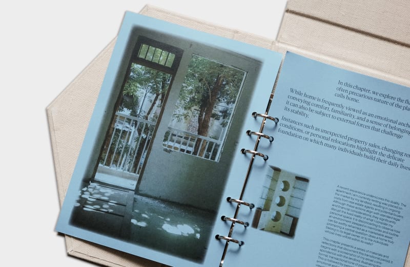 A linen-bound booklet opens to reveal layered pages, printed questions, and nostalgic photographs, exploring what makes us feel at home.
