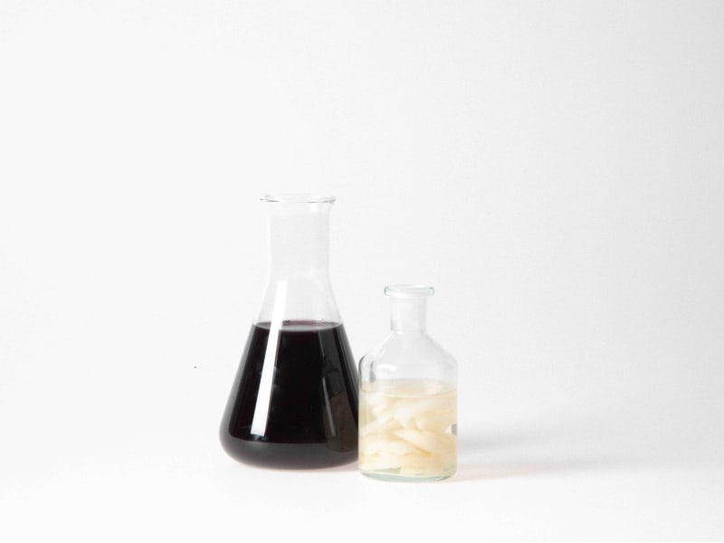 An image of two scientific flasks containing each element of the project.