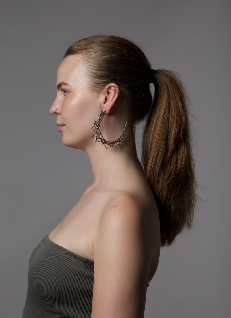 angle, hoop earrings and ring all made out of sewing needles. spikey in appearance. needles are high polished with gemstones tension set.