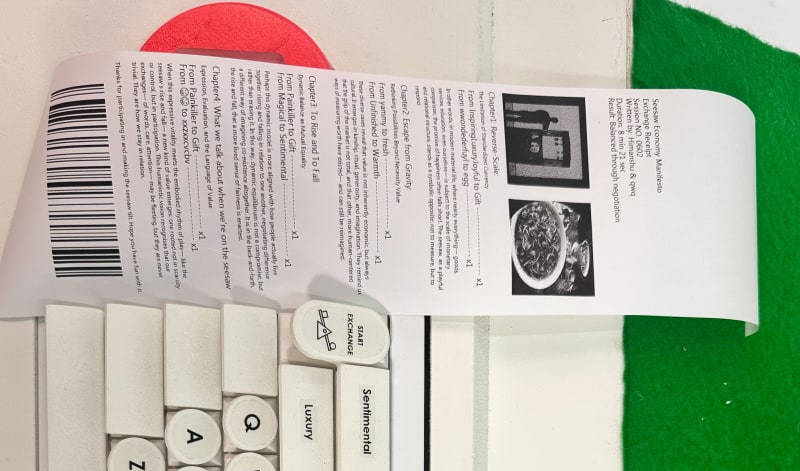 Below the seesaw is a retro-style white keyboard and a small thermal printer, which has printed a narrow receipt.