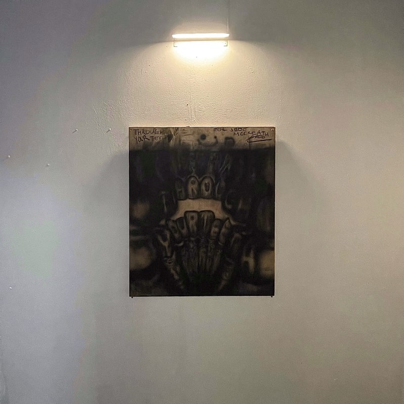a drawing of teeth on a wooden panel.