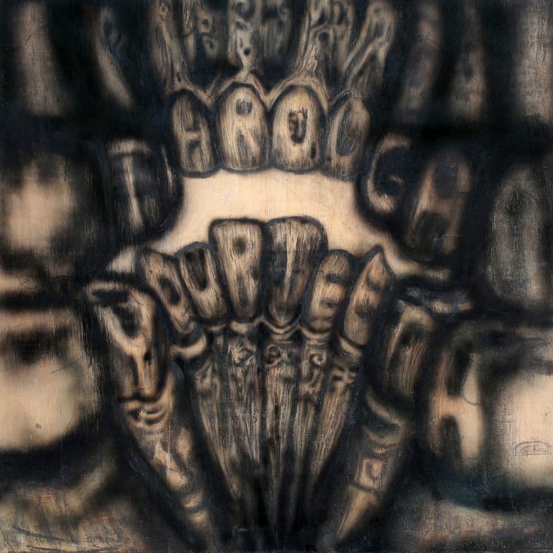 a drawing of teeth on a wooden panel, closest.