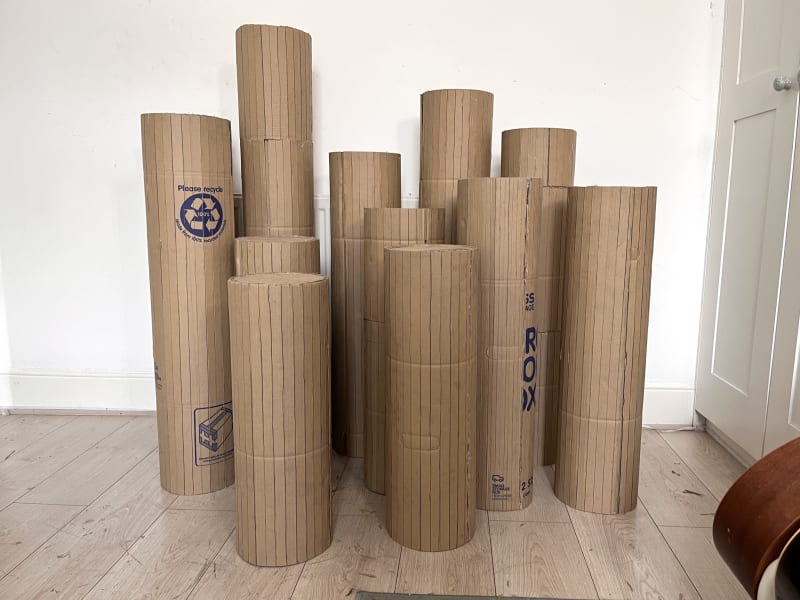 11 cylindrical structures made from cardboard