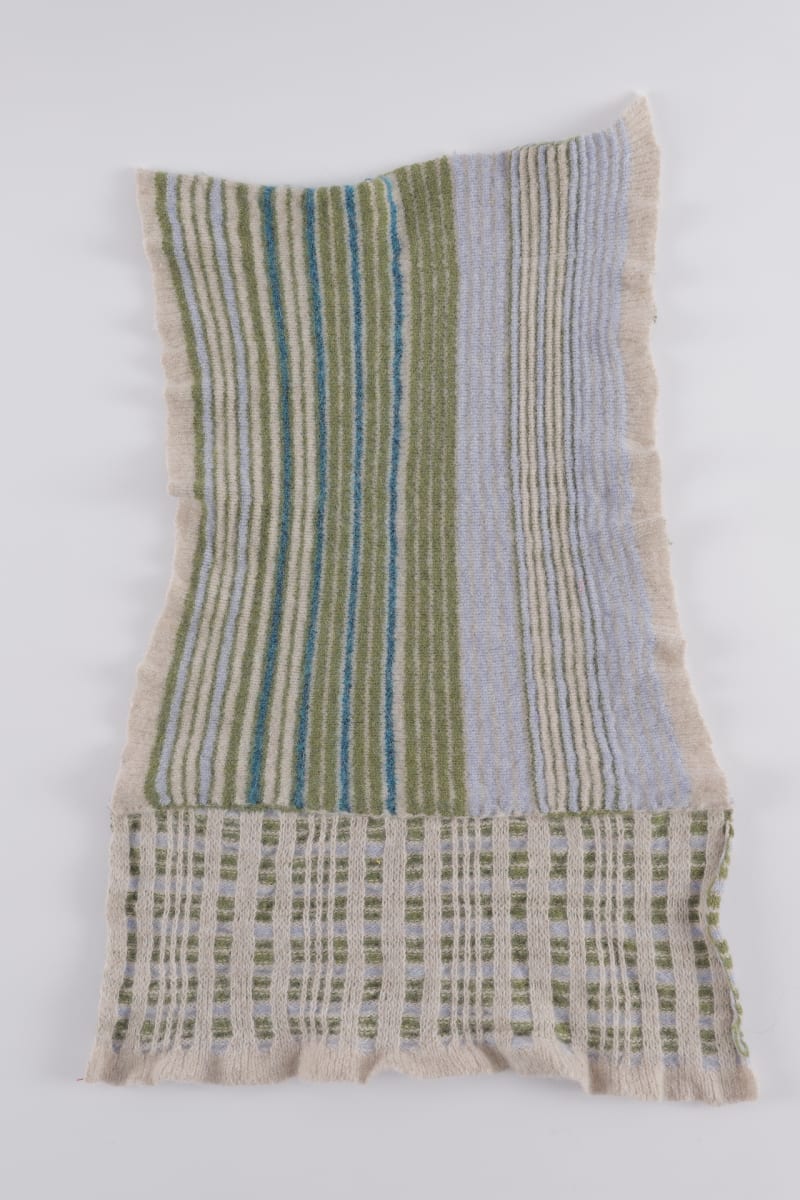 A blue, green and cream striped and tartan sample.