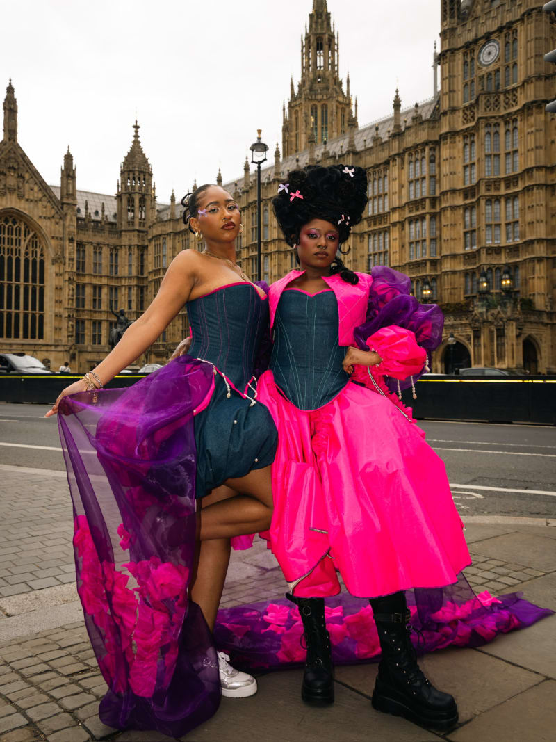 Two women standing infant of the houses of parliament