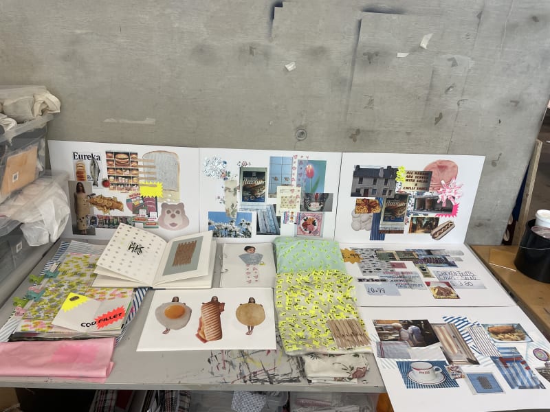 table with mood boards and sketch books 