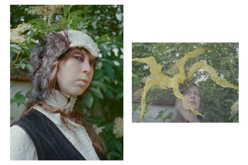 Portraits of a model wearing a knit bird balaclava head piece and a model wearing a yellow knit flower hat 