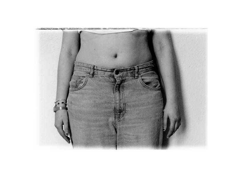 Black and white cropped images of a young woman dressed in jeans torso. 