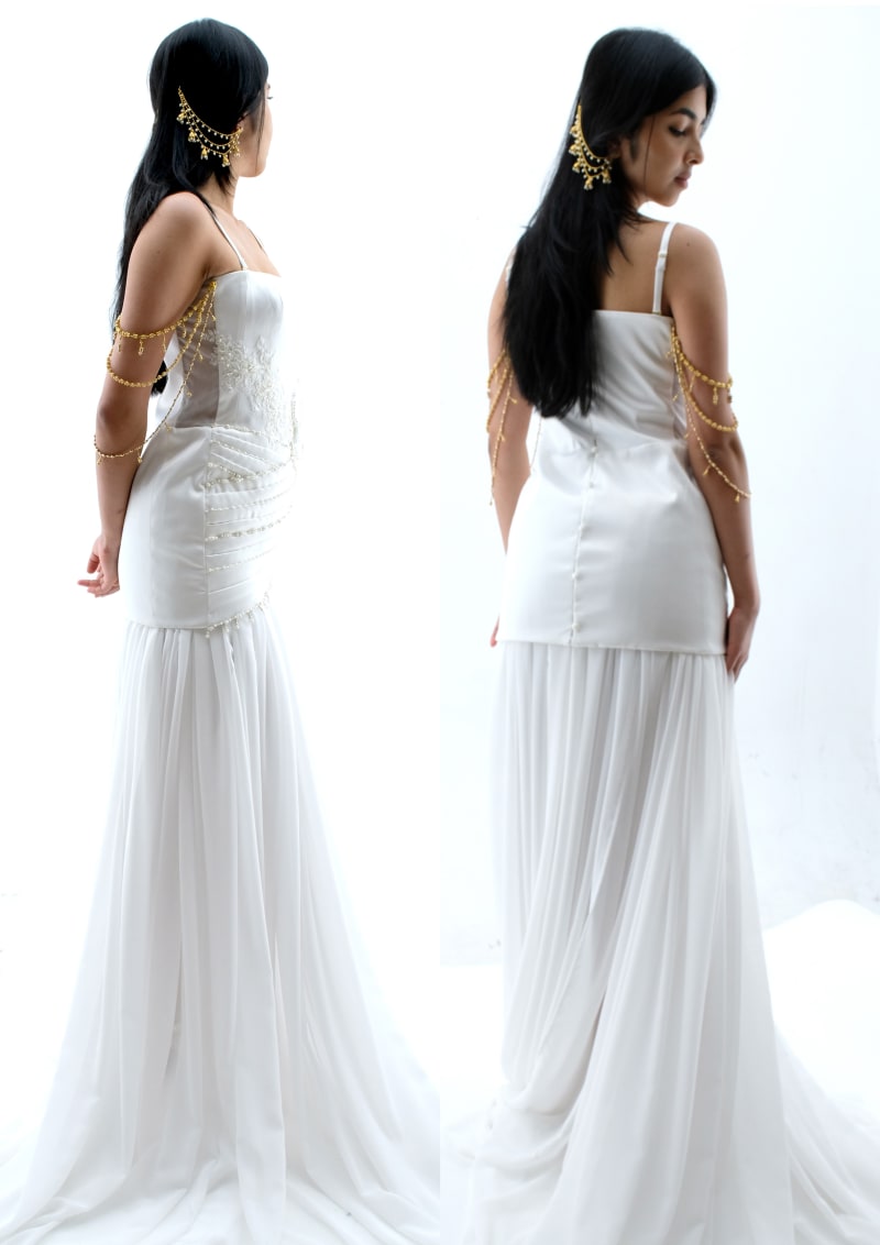 Highly embellished white satin gown with detachable beading and loops paired with white chiffon gathered underskirt.