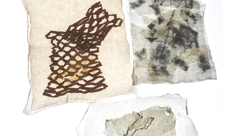 Three textile pieces made with Korean paper, featuring abstract prints and compressed forms, highlighting delicate fibres and layered translucency.