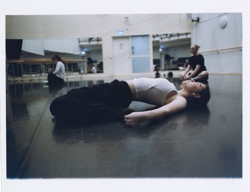 The photos shows one of the girls stretching her back before dance.