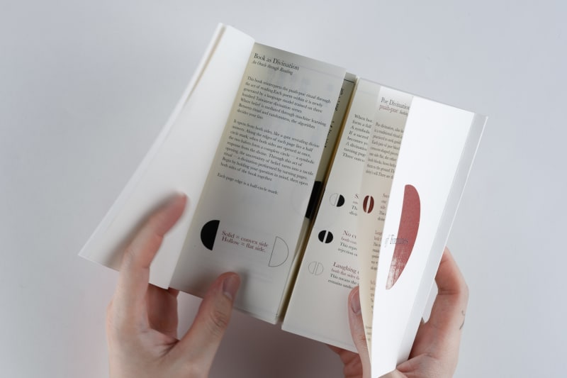A person opens a white book titled Gate of Fortunes, revealing divination poems printed on both sides.