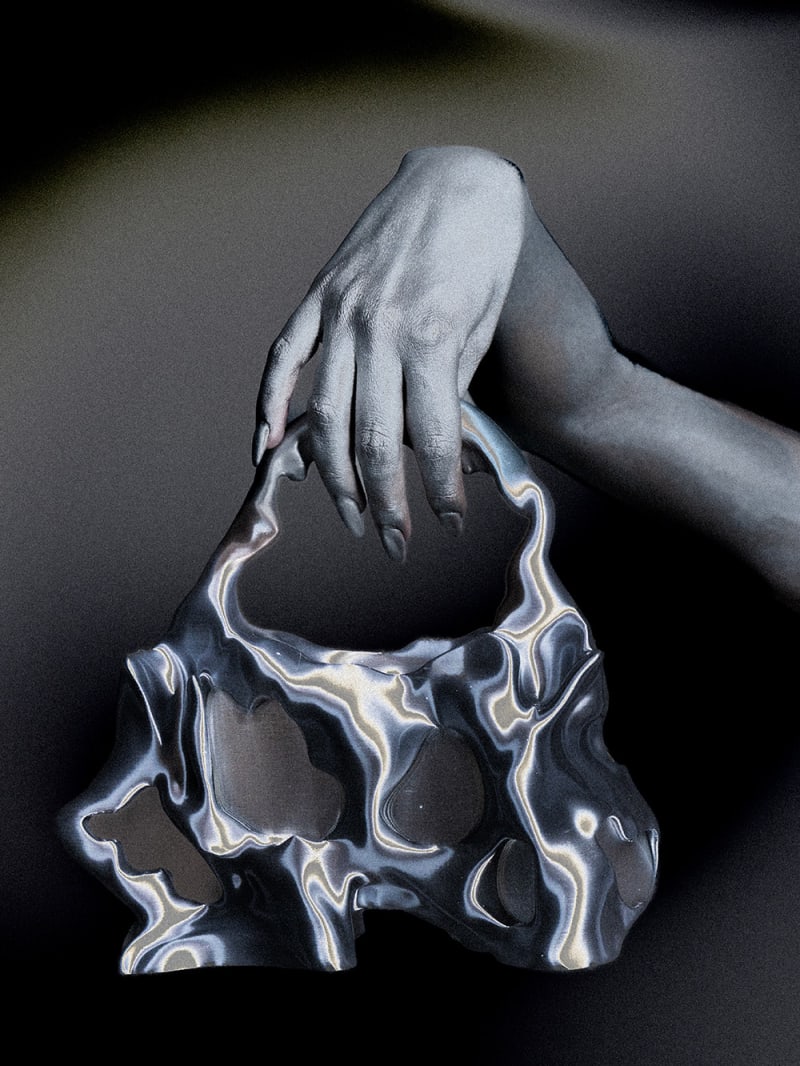 silver hand holding chrome bag.