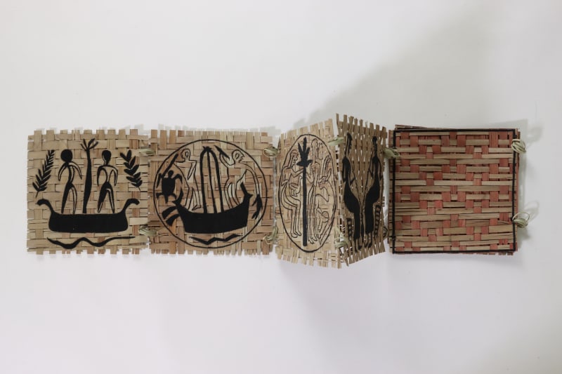 Woven palm leaf structures with embroidery of ancient motifs in a book format.
