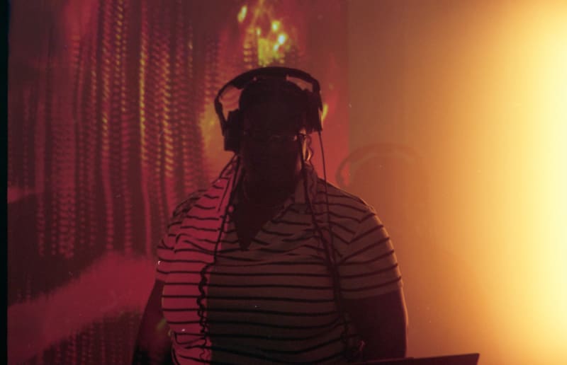 red/orange gradient photographs of a female person with headphones.