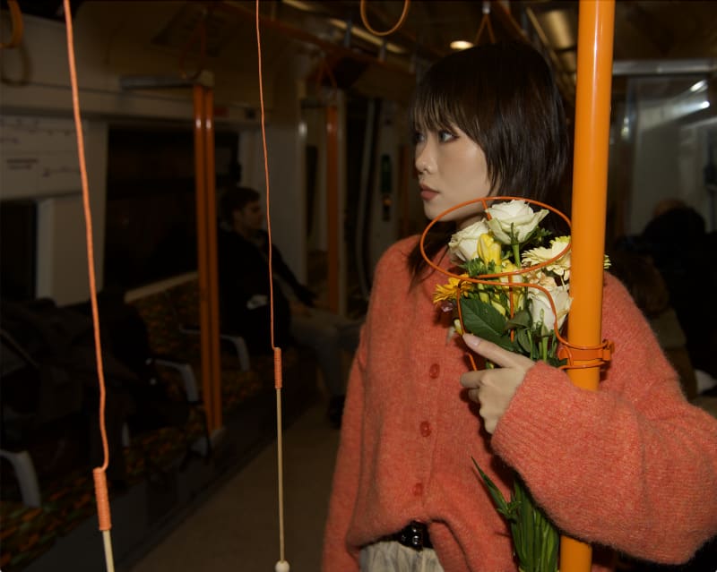 A powder-coated linear metal sculpture which replaces the standing pole in overground carriage and could hold a big bunch of flowers.