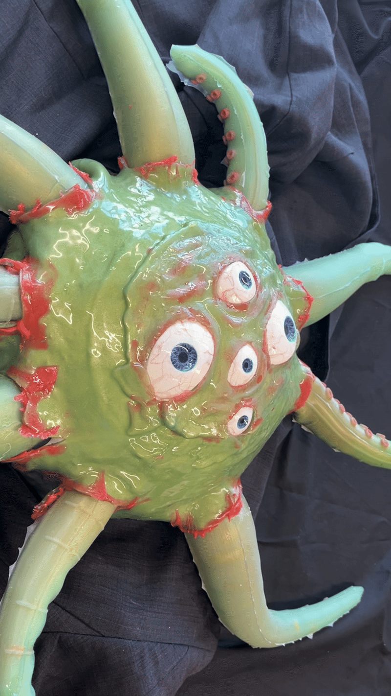 Green tentacle monster bursting out of a jacket.