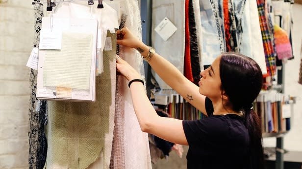 A woman looking at materials hung on a wall