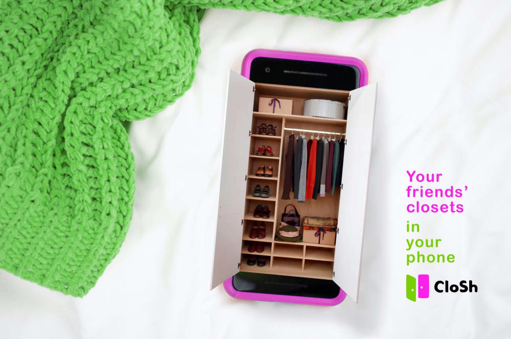 flatlay showing a wardrobe coming out of a phone, and a green jumper beside it