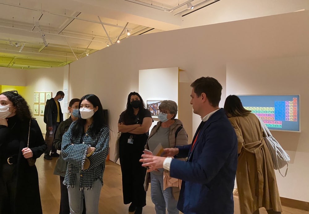 Group of people listening to a curator talk