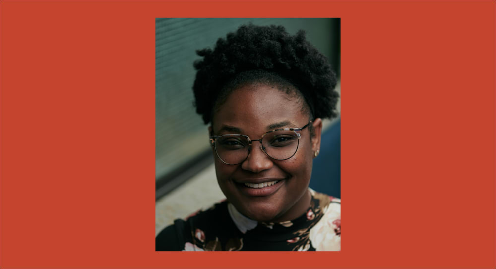 Portrait photograph of a woman smiling at the camera.
