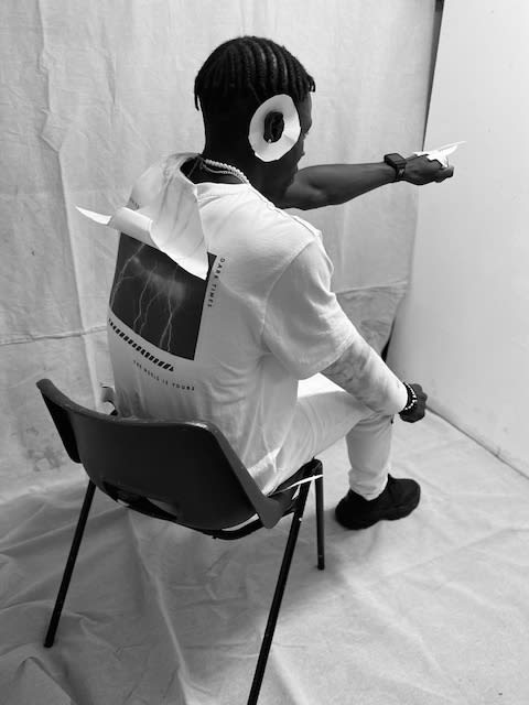 Student sat on chair with paper vest